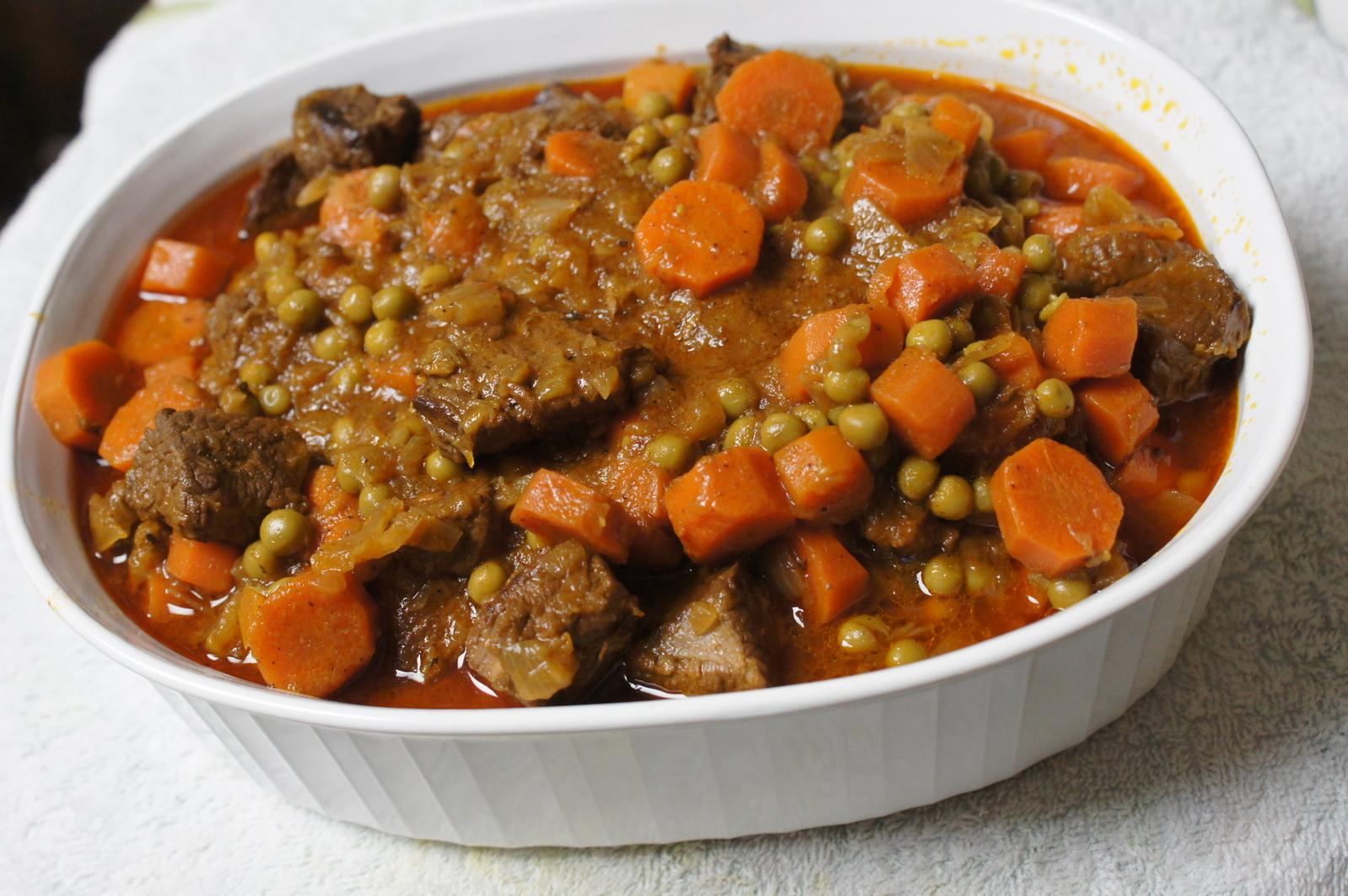 A spoonful of tender and buttery beef nestled in a bed of peas.