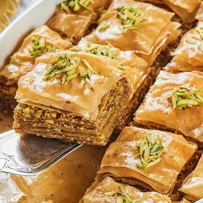  Each slice of the baklava reveals delicate layers of pastry enveloping the flavorful filling inside.