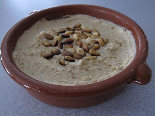 Elevate your hummus game with this recipe featuring buttery pine nuts.