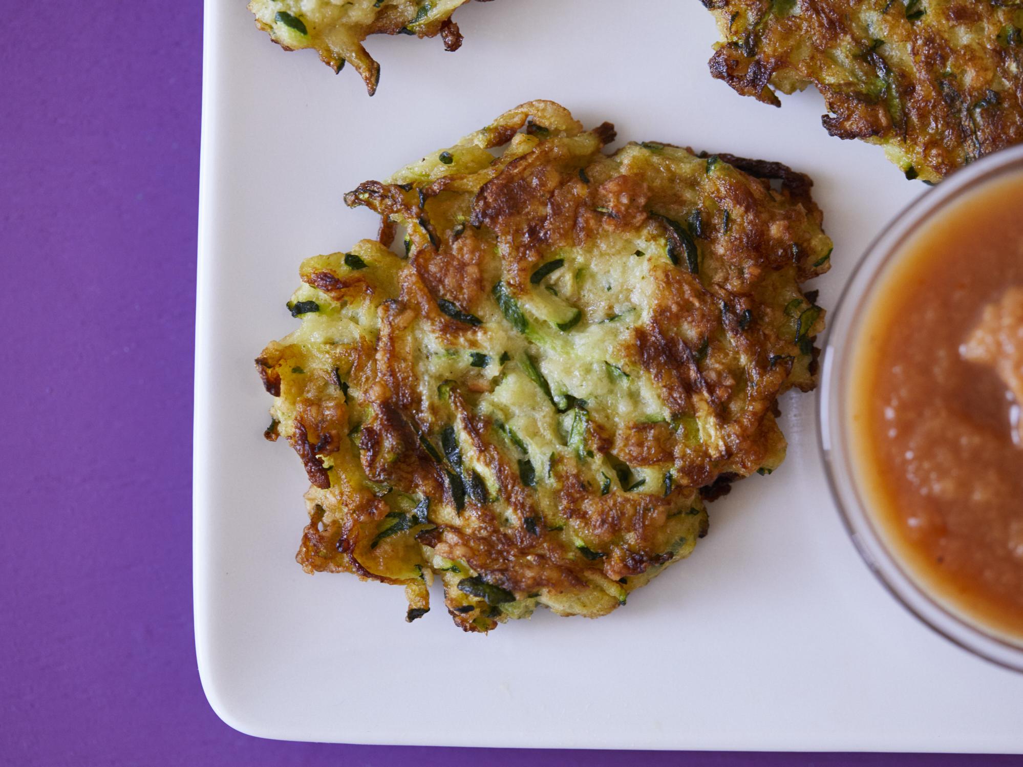  Golden brown zucchini latkes, crispy on the outside and soft on the inside.