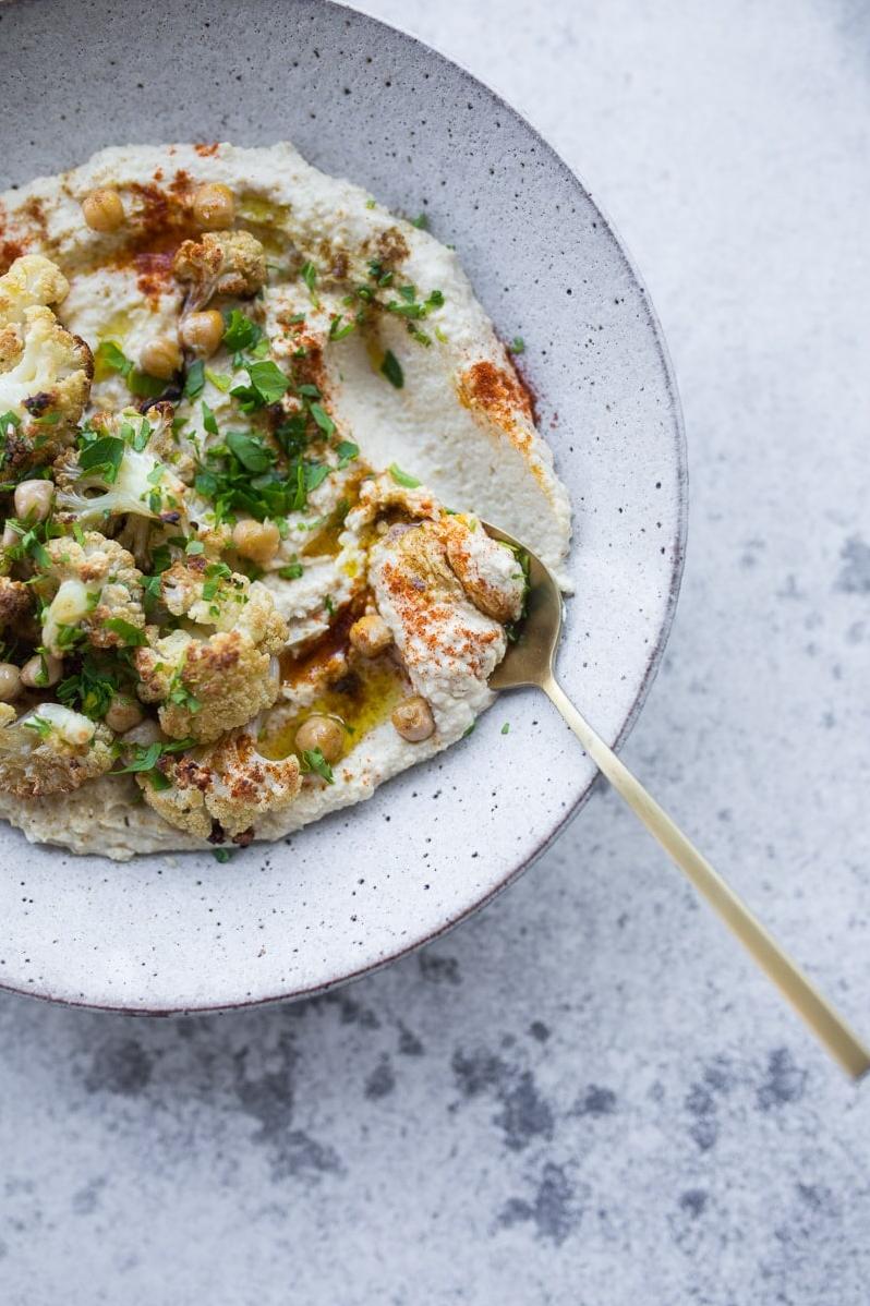  Golden roasted cauliflower and zucchini team up for the ultimate vegan hummus alternative.