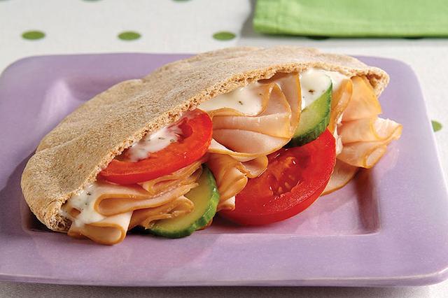  Layers of thinly sliced turkey and brie cheese make this pita taste like it's straight from the deli case.