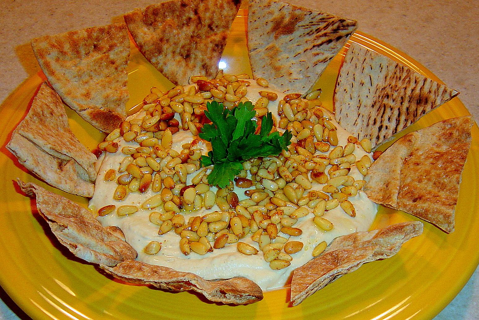  Make your hummus pop with a garnish of fragrant pine nuts.