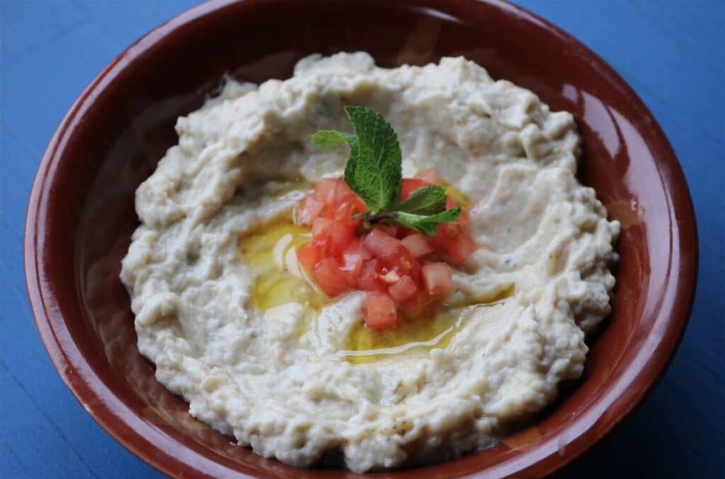  The vibrant green parsley sprinkles on top of the Baba Ghanoush bringing a pop of color and a refreshing herby taste.